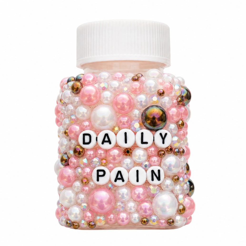 Jar labeled 'Daily Pain' covered in pink and gold beads on a white background