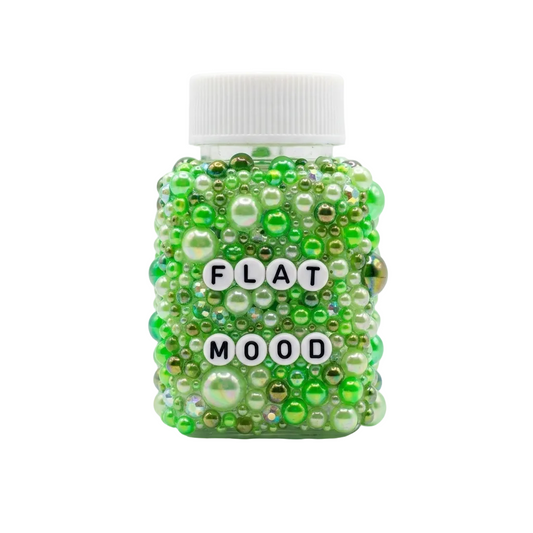 Jar labeled 'Flat Mood' covered in green beads on a white background