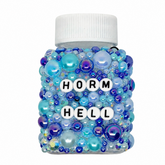 Decorative bottle with blue and purple beads and visible text on a white background